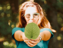 Photograph of a student holding a green leaf