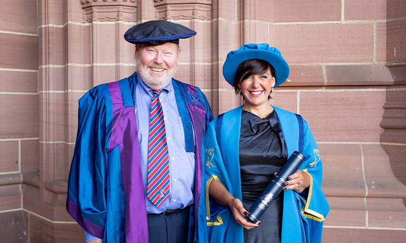 Roger Philips alongside Angela Samata after she received her honorary fellowship from LJMU. Both wear graduation gowns. 