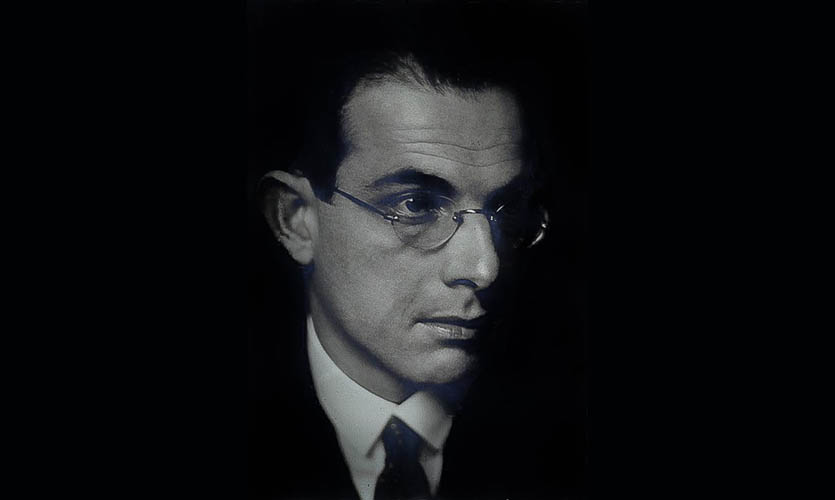 Black and white photograph of the face of George Mayer-Marton he has dark hair and is wearing circular frameless glasses