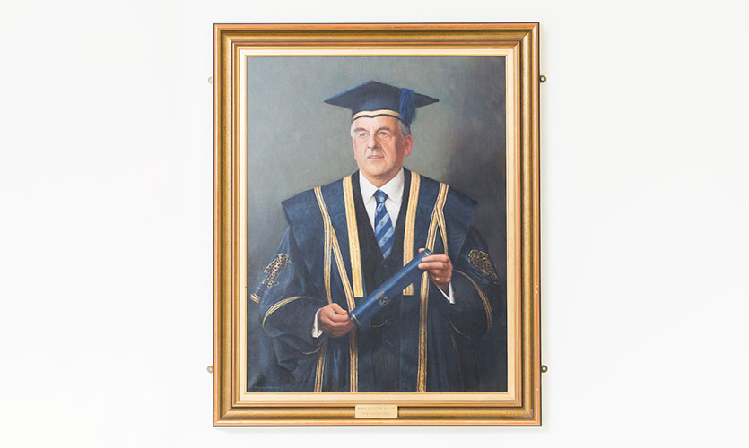 A painted portrait of Henry dressed in a cap and gown
