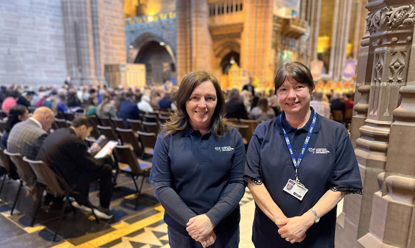 Lisa standing and smiling with another person in the Anglican Cathedral Liverpool