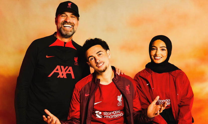 Selma sat down wearing her hijab over her hair and a Liverpool FC shirt with Liverpool player Curtis Jones to her left and Liverpool manager Jurgen Klopp next to him