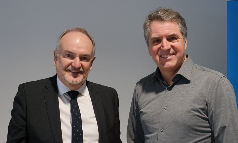 Head and shoulders photo of Steve Rotheram smiling stood next to another smiling man who is Vice-Chancellor of LJMU Mark Power
