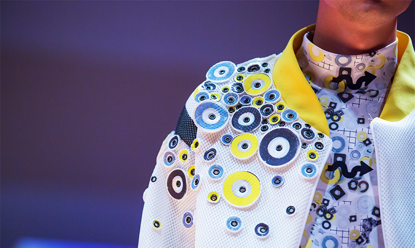 Blue and yellow circles detail on a man's white jacket