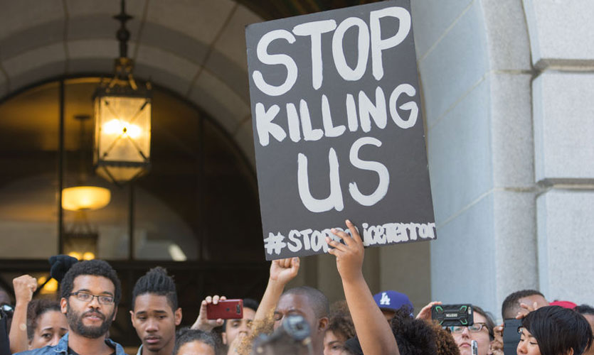 Black Lives Matter protestors holding a sign outside LA City Hall