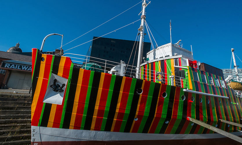 Ferry painted in multi-coloured stripes