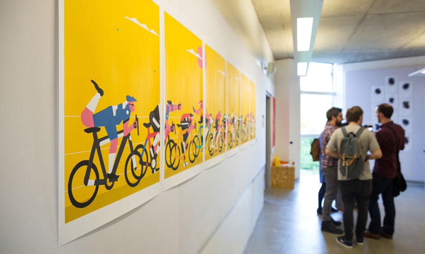 Yellow artworks depicting cartoon cyclists