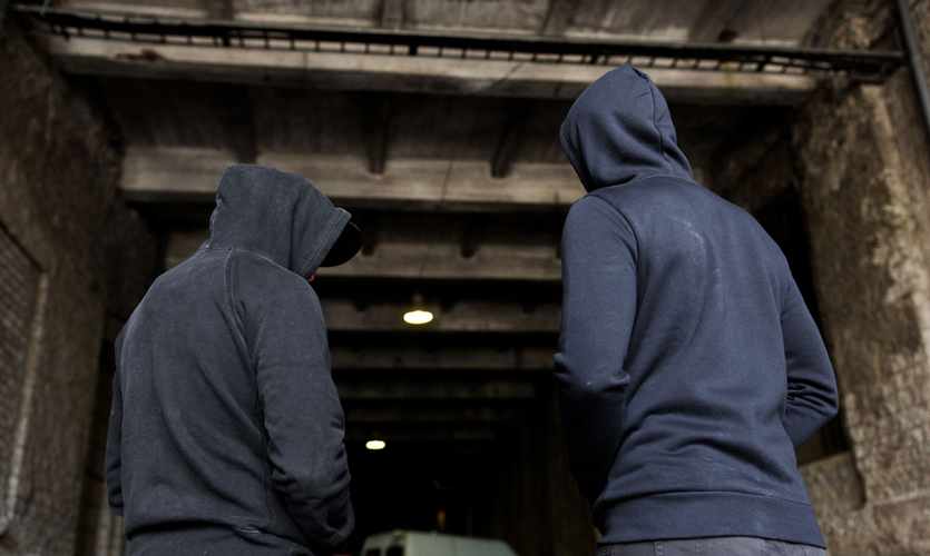 Two figures in hoodies