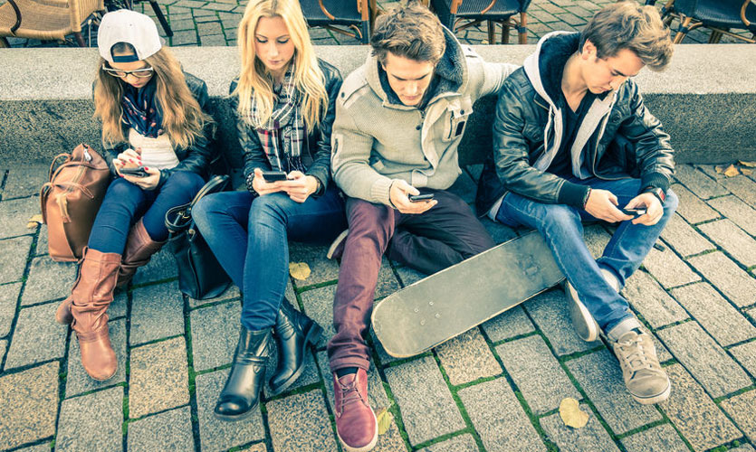 Group of young people, each using their phones