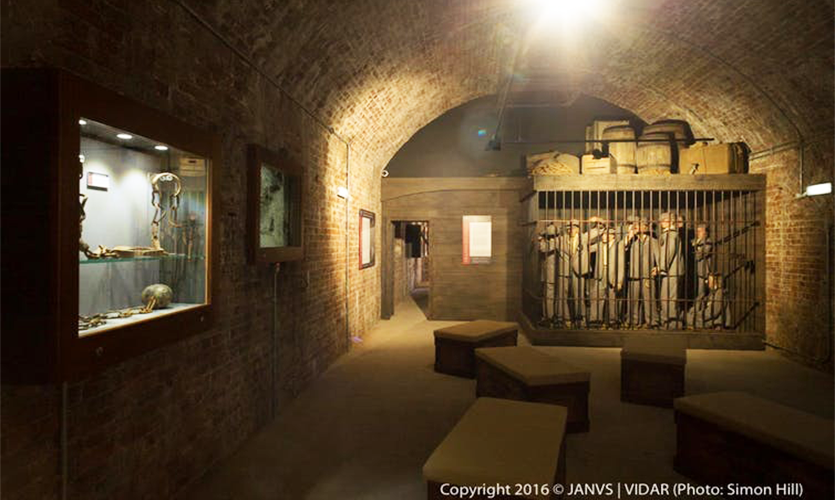 Image of an exhibition showing prisoners in a cell inside Spike Island