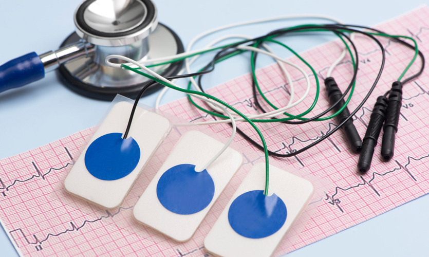 A stethoscope, monitors and ECG print out