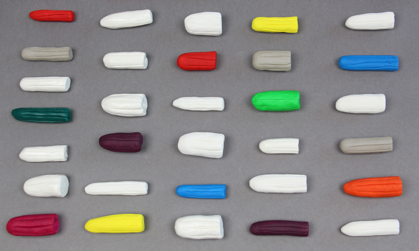 A display of colourful tampons sculpted in clay