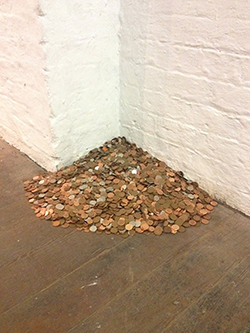 A pile of silver and copper coins representing £306 average annual spend on menstrual products and pain relief