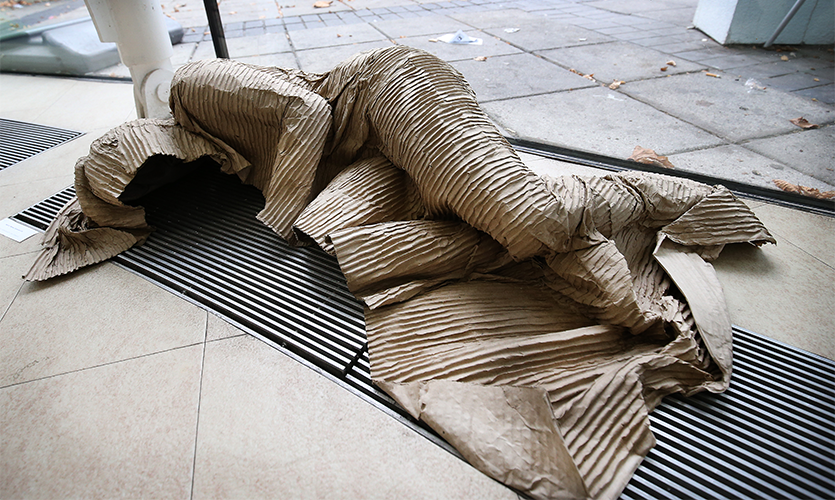 Cardboard sculpture of a human outlinelying down