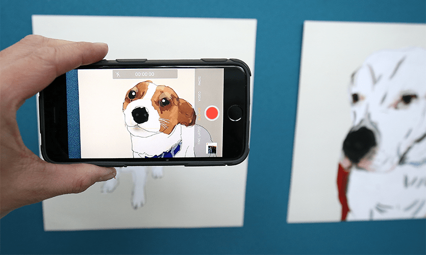 Painting of a dog viewed through a smartphone's screen