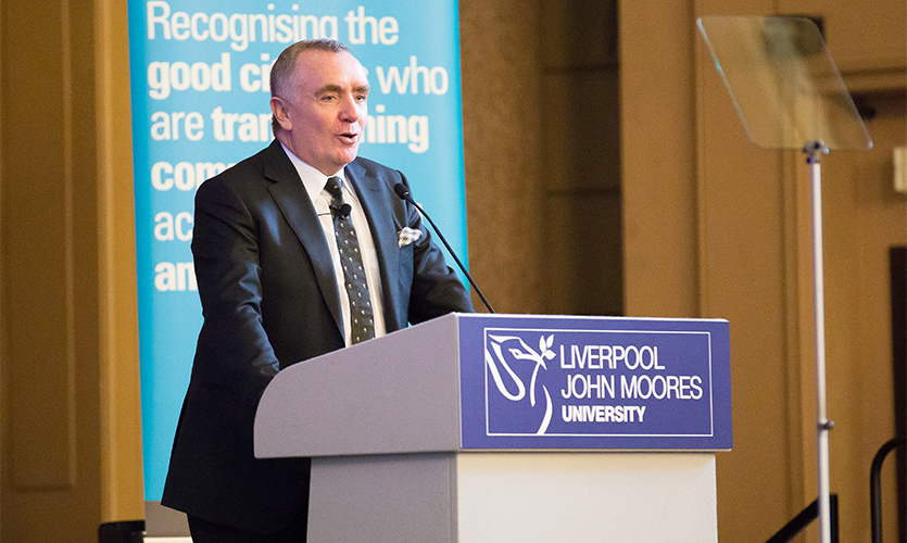 Ian Ayre standing at a podium delivering his Roscoe Lecture