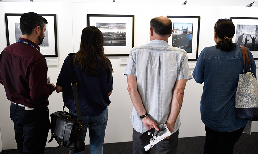 People looking at pictures in the exhibition space