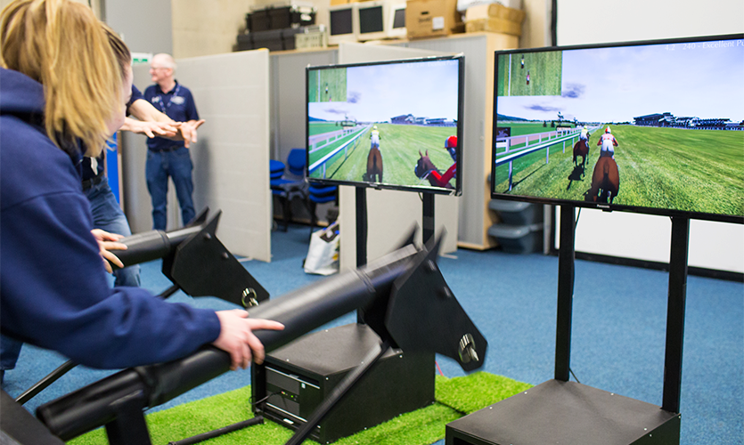 school pupils experiencing the demands of being a jockey on Racewood Ltd’s horse simulator
