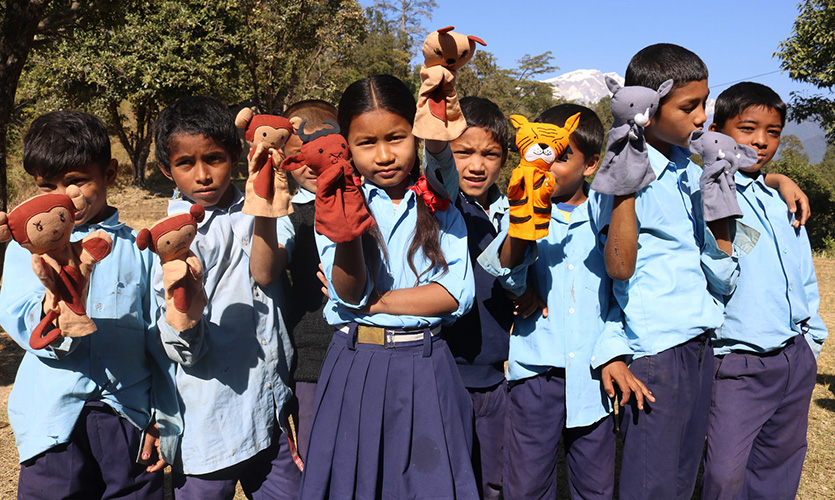 Nepalese children show off their puppets