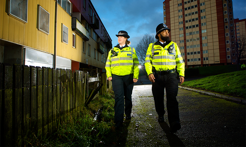 Image of two police officers walking down a path
