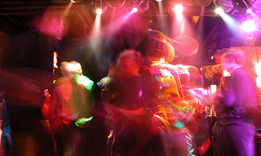 Long exposure shot of revelers dancing in a nightclub