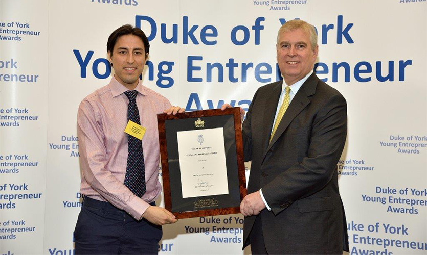 Marketing graduate Mark Russell receiving his award