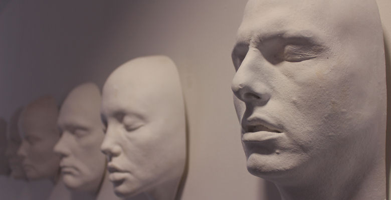 Image of facial reconstructions on white wall