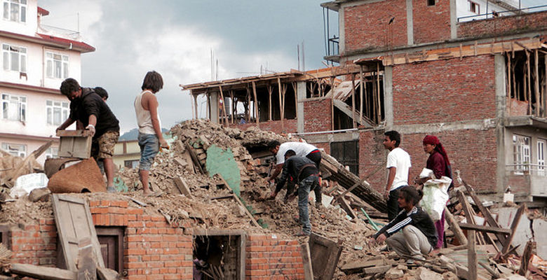 Image of survivors searching through rubble in Nepal