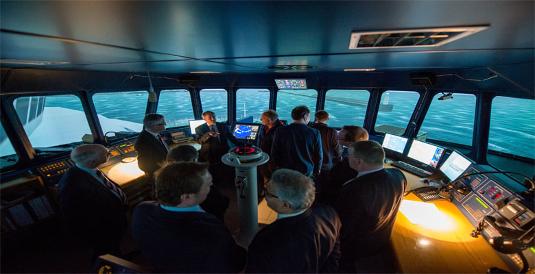 Shipping Minister inside maritime simulator with LJMU and Mersey Maritime staff