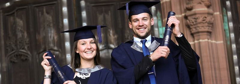 Image of Gemma Fisher and  Harry Smither in cap and gown