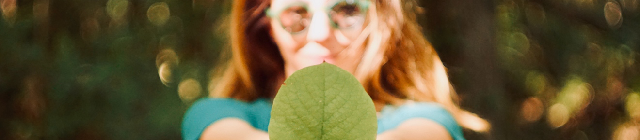 Photograph of a student holding a green leaf