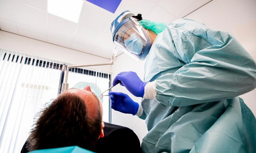 Image of a dentist wearing personal protective equipment