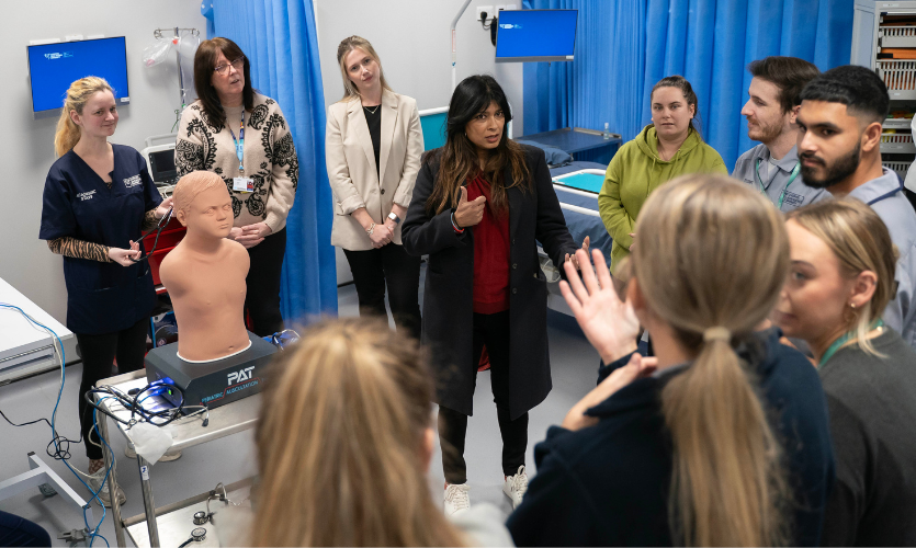 Nisha stood with a group of nursing students on a simulated hospital ward
