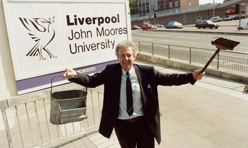 The university’s first Vice Chancellor Peter Toyne stood in front of the university’s first logo he’s just stuck to a building in 1992