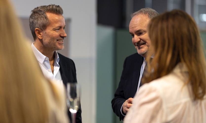 LJMU Vice Chancellor Mark Power pictured smiling as he talks to a member of the Moores family at a Littlewoods exhibition event 