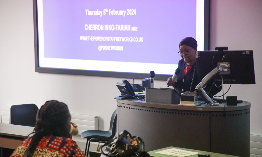LJMU's Associate Director Diversity and Inclusion speaking at the front of a lecture hall 