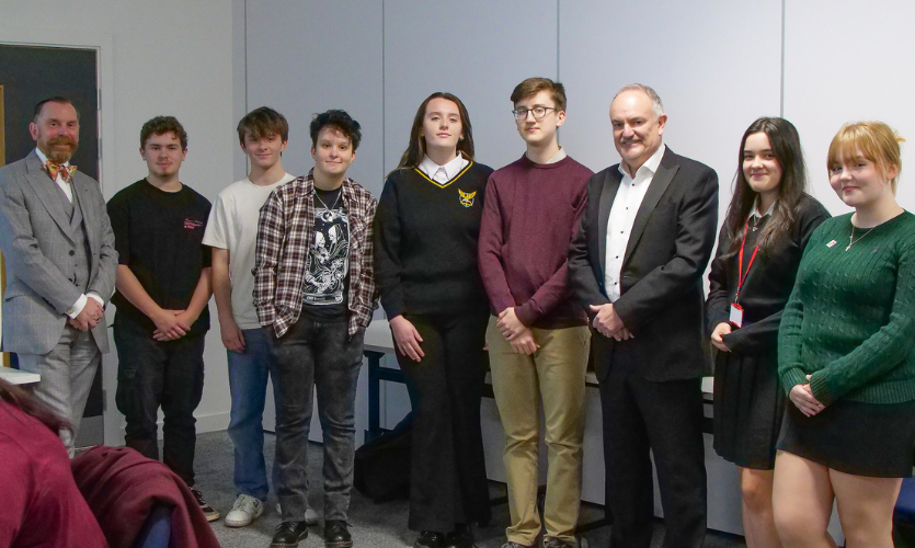 Seven school pupils stood with Vice-Chancellor Mark Power and subject leader for History David Clampin