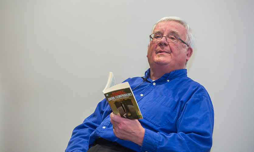 Ramsey Campbell holding a copy of his book