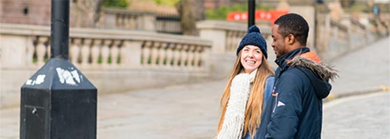 Image of two students talking outside the Central Library in Liverpool