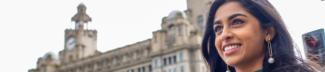 Student beside the Liver Building
