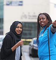 Image of a student getting help from an LJMU staff member