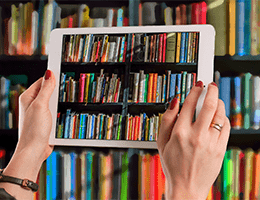 Image of an ipad taking a photo of some books