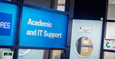 Windows to a room with the LJMU logo on them saying Academic and IT Support