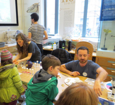 Image of scientists with children at museum