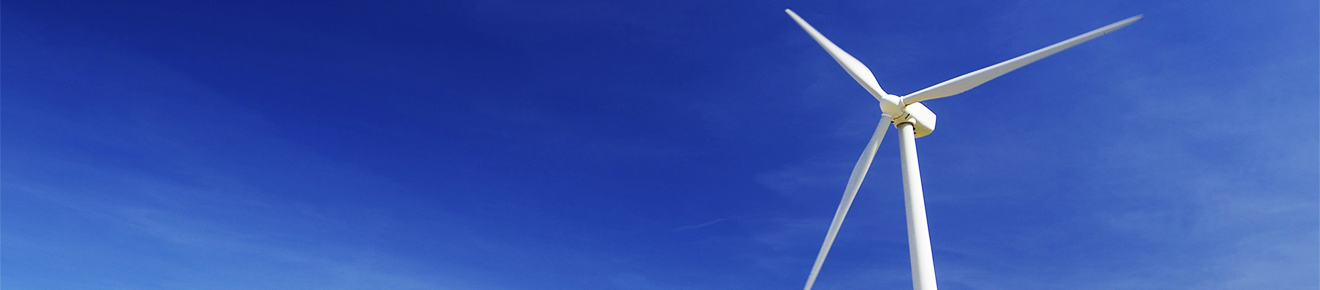 Image of a wind turbine against a blue sky.
