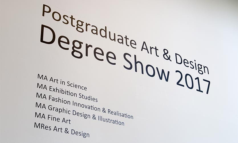 Stencil on a white wall saying "Postgraduate Art & Design Degree Show 2017"