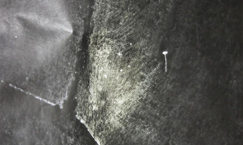 Close up image of graphite paper showing scratches on the surface