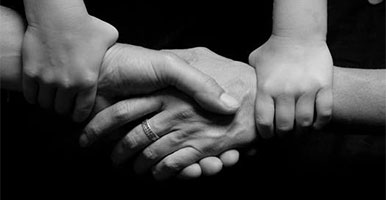 Childs hand holding Adult hands